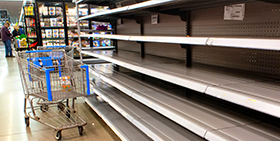 Country & Sector Risk Barometer: Q3 2021 Quarterly Update. The image shows a trolley in front of empty shelves in a supermarket.